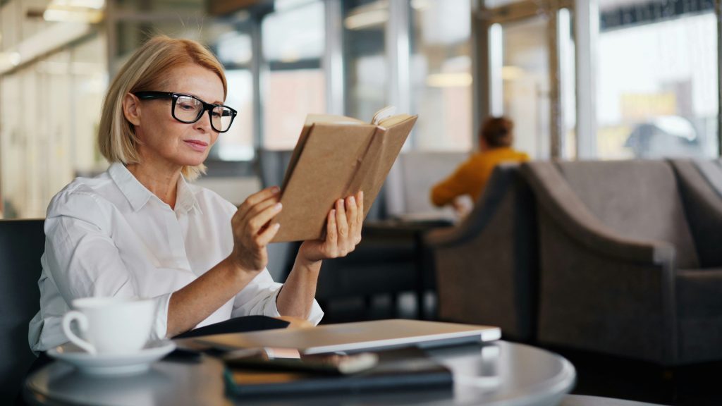Person reading comfortably while wearing glasses