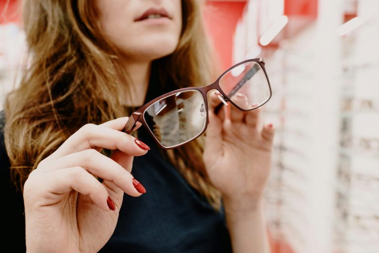 Person trying on reading glasses while choosing frames