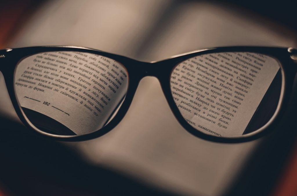 Reading glasses placed on an open book